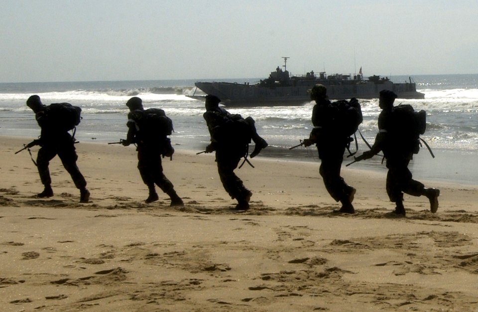 US Navy 051015-F-5789F-040 Ghanaian soldiers run to their positions while engaged in amphibious operations in southwest Ghana during the West African Training Cruise '06 (WATC)