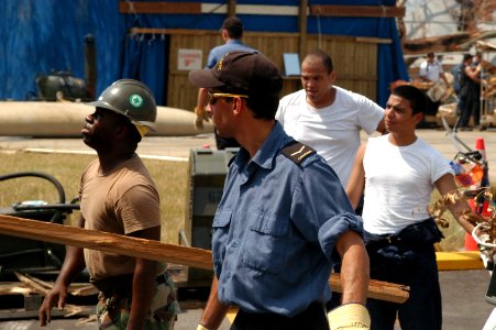 US Navy 050914-N-0793G-001 U.S. Navy Seabees with Construction Battalion Maintenance Unit 202, work with Canadian Sailors and other Sailors assigned to the amphibious assault ship USS Bataan (LSD 5) to clean up the compound at