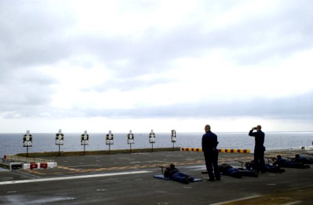 US Navy 050914-N-9866B-032 Two gunner's mates supervise several Sailors as they take part in a M-14 rifle qualification on the flight deck of the amphibious assault ship USS Peleliu (LHA 5)
