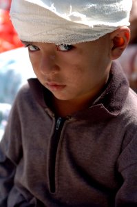 US Navy 051014-N-8796S-056 A Pakistani boy waits to receive medical attention after being airlifted by a U.S. Navy MH-53E Sea Stallion helicopter