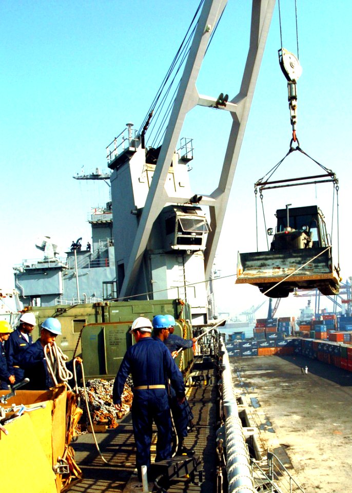 US Navy 051018-N-0716S-004 The crew aboard the dock landing ship USS Pearl Harbor (LSD 52) unloads a bulldozer from its flight deck in Karachi, Pakistan