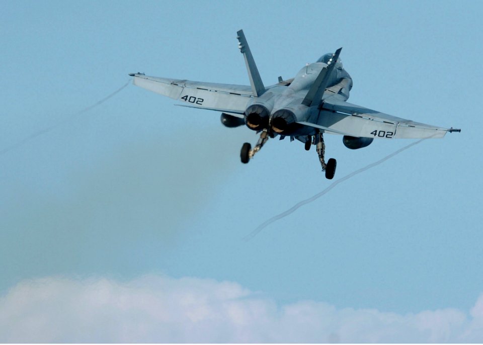 US Navy 051025-N-3488C-089 An F-A-18C Hornet, assigned to the Golden Dragons of Strike Fighter Squadron One Nine Two (VFA-192), lifts from the deck performing a touch and go landing
