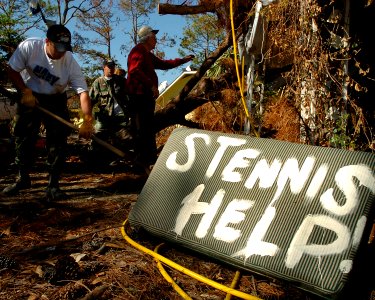 US Navy 051026-N-3729H-046 U.S. Navy Machinist Mate Fireman Andrew Westermire, assigned to the Nimitz-class aircraft carrier USS John C. Stennis (CVN 74), helps local Ken Tine clear his driveway in Pass Christian