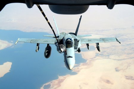 US Navy 051012-F-5480T-002 An F-A-18C Hornet refuels from a U.S. Air Force KC-10 Extender aerial tanker while conducting a mission over the Persian Gulf