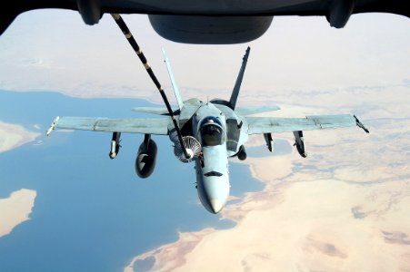 US Navy 051012-F-5480T-002 An F-A-18C Hornet refuels from a U.S. Air Force KC-10 Extender aerial tanker while conducting a mission over the Persian Gulf photo