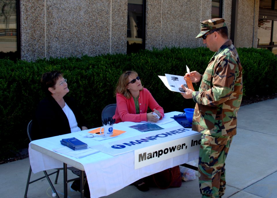 US Navy 051031-N-1132S-001 Chief Alan Reling, assigned to Naval Mobile Construction Battalion Seven (NMCB-7), speaks with representatives Lynn Spencer and Michelle Hauptmann at a job fair