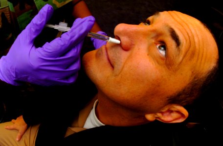 US Navy 051028-N-9769P-002 Senior Chief Navy Counselor David Paradise, assigned to Commander Naval Recruiting Command, receives his annual Influenza vaccine in the form of a nasal mist