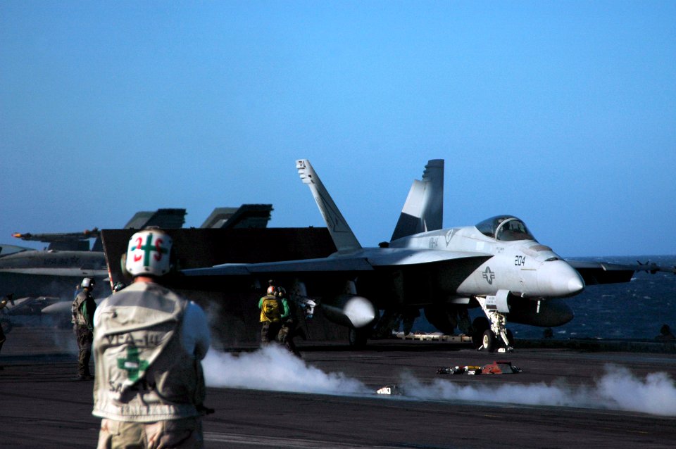 US Navy 051013-N-3570S-007 A safety officer observes the movement of an F-A-18E Super Hornet as it readies for launch on the flight deck aboard the nuclear-powered aircraft carrier USS Nimitz (CVN 68)
