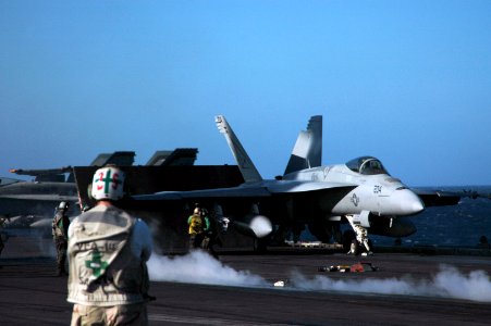 US Navy 051013-N-3570S-007 A safety officer observes the movement of an F-A-18E Super Hornet as it readies for launch on the flight deck aboard the nuclear-powered aircraft carrier USS Nimitz (CVN 68)