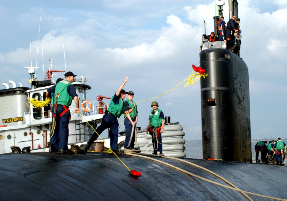 US Navy 051018-N-0780F-007 A Sailor heaves a line ashore as the Los Angeles-class attack submarine USS San Juan (SSN 751) arrives for a brief port visit in Greece