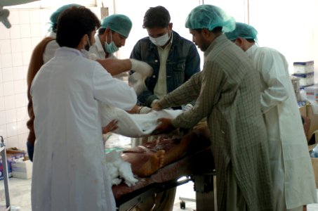 US Navy 051013-N-8796S-208 Pakistani doctors operate on an injured woman at one of the only hospitals left operational in the city of Muzafarabad, Pakistan