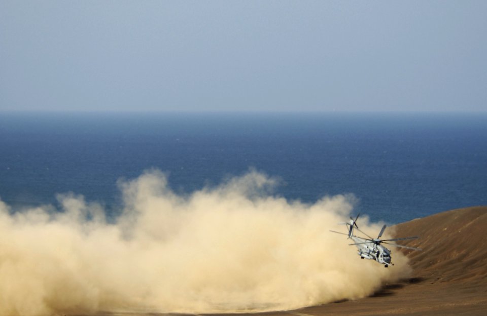 US Navy 050927-F-7234P-111 A Marine Corps CH-53 Sea Stallion helicopter kicks up sand as it makes its way along the Gulf of Tadjoura, Djibouti