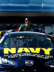 US Navy 051022-N-9769P-300 NASCAR driver David Stremme stands behind the No. 14 Navy Accelerate Your Life Dodge Charger photo