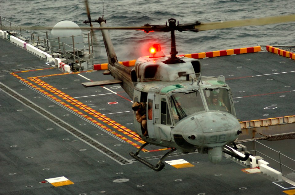 US Navy 051108-N-9866B-177 A UH-1N Huey helicopter, assigned to Marine Light Attack Helicopter Squadron Two Six Seven (HMLA-267), lands on the flight deck of the amphibious assault ship USS Peleliu (LHA 5)