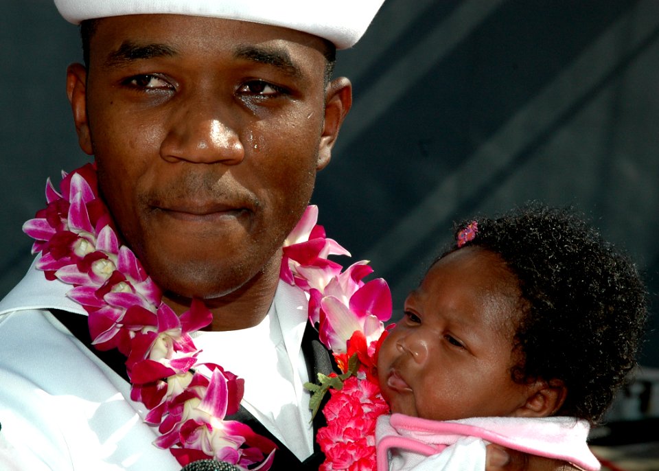 US Navy 051109-N-3019M-001 A Sailor assigned to the guided missile destroyer USS Chafee (DDG 90), embraces his daughter after returning to Naval Station Pearl Harbor, Hawaii