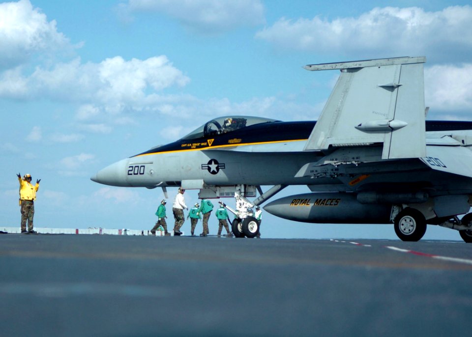 US Navy 051025-N-3488C-023 Aviation Boatswain Mate 2nd Class Paul Young directs an F-A-18E Super Hornet