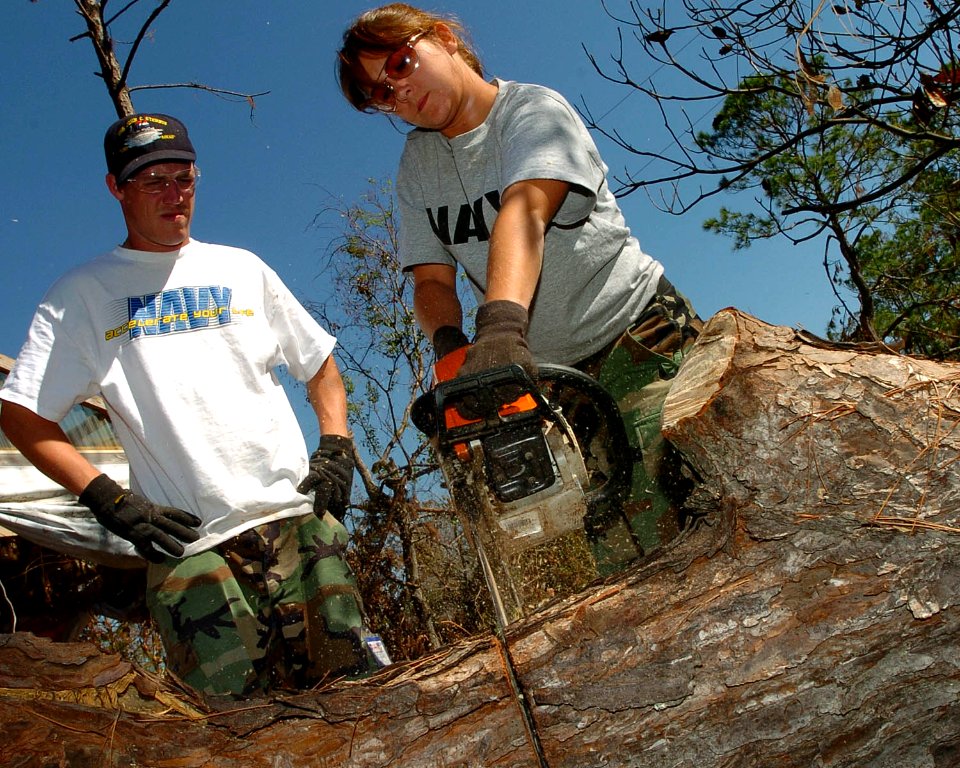 US Navy 051026-N-3729H-077 U.S. Navy Airman Salvatore Lombardi and Photographer's Mate 3rd Class Randi Brown, both assigned to the Nimitz-class aircraft carrier USS John C. Stennis (CVN 74), help locals clear their drivew