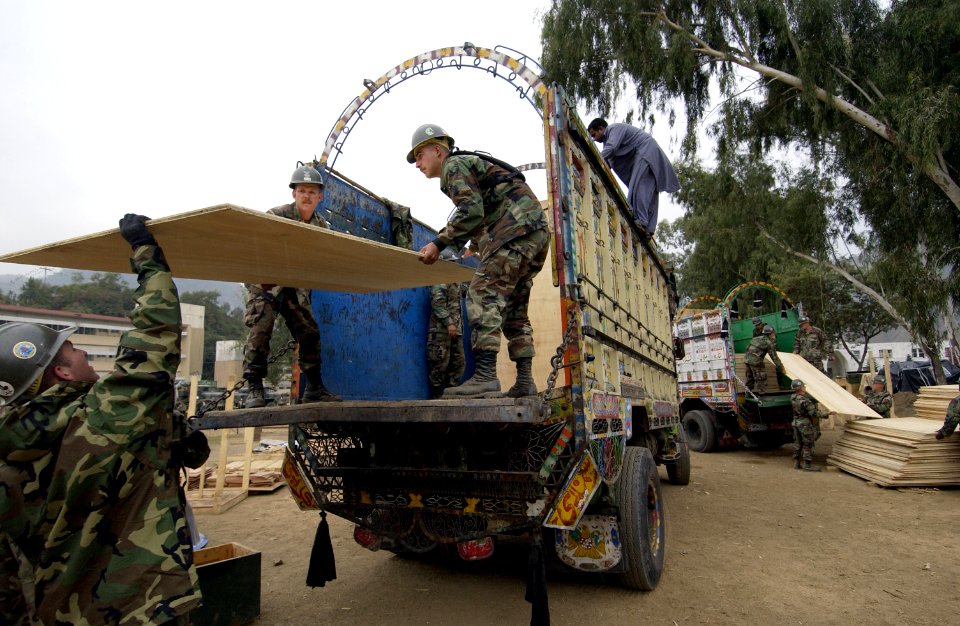US Navy 051110-F-2729L-009 U.S. Navy Seabees assigned to Naval Mobile Construction Battalion Seven Four (NMCB-74), unload plywood from a truck in Muzaffarabad, Pakistan