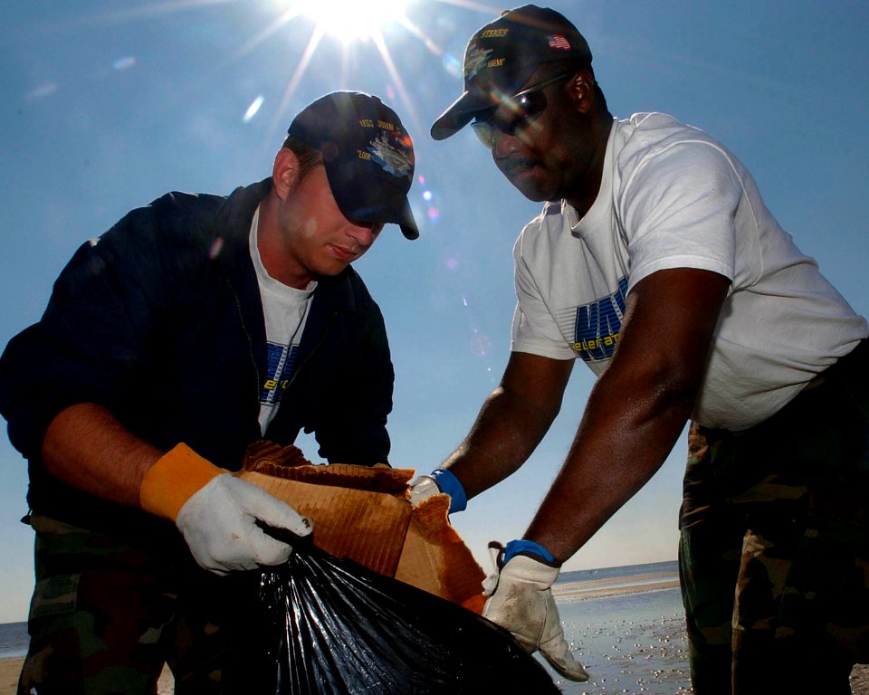 US Navy 051025-N-3729H-072 Sailors assigned to Nimitz-class aircraft carrier USS John C. Stennis (CVN 74) gather debris on a beach in Waveland, Miss