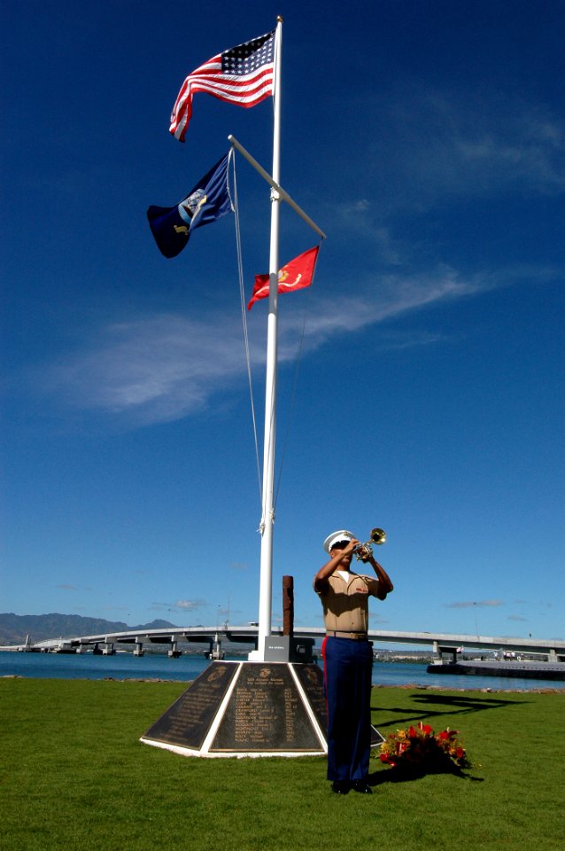US Navy 051114-N-3019M-004 U.S. Marine Corps Sgt. Louis Magana echoes taps on his bugle during a ceremony dedicating a new flagstaff and display of bronze plaques