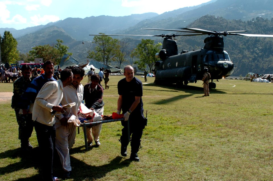 US Navy 051012-N-8796S-260 Members of the Pakistan military and civilians from multinational relief agencies carry an injured woman to a U.S. Army UH-60 Blackhawk helicopter for a medical evacuation in the remote Pakistani vill