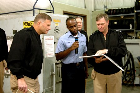 US Navy 051025-N-9999L-001 Commander, Naval Air Systems Command, Vice Adm. Wally Massenburg, right, and Assistant Commander, Aviation Deports, Rear Adm. Pete Williams, check supply records