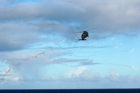 US Navy 051104-N-8158F-155 An HH-60H Seahawk helicopter demonstrates aerial missile countermeasures by firing chaff and flares during an airpower demonstration