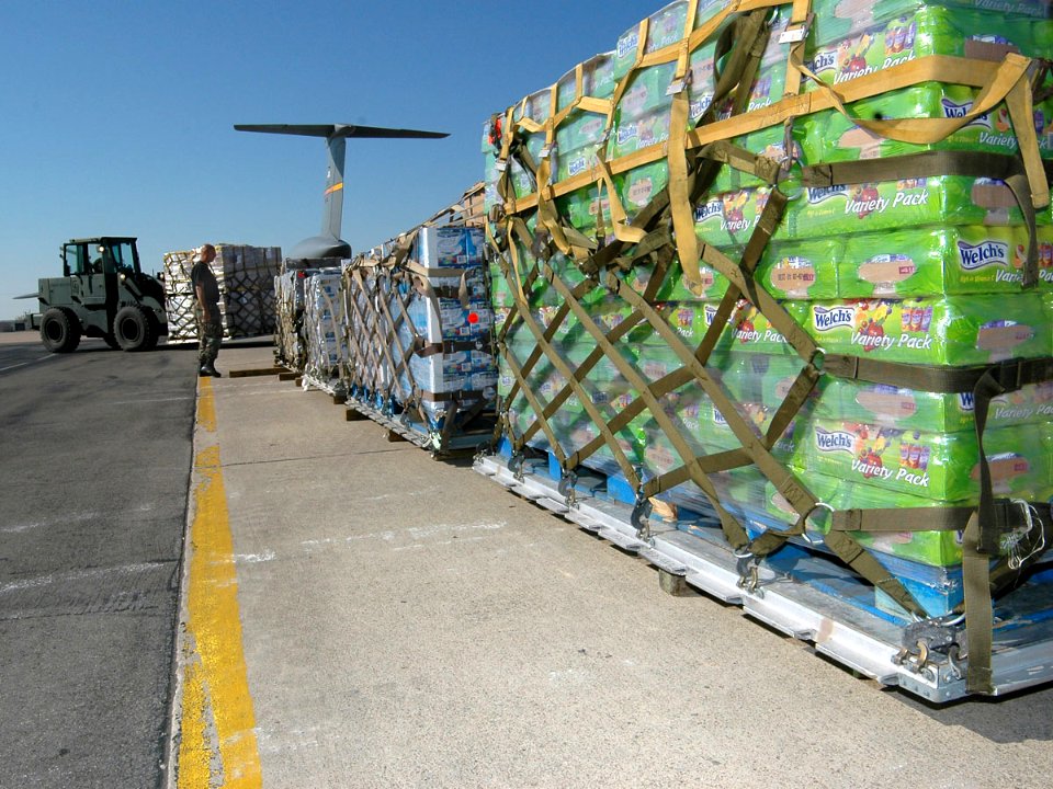 US Navy 051028-N-1328C-539 Food and water supplies for victims of Hurricane Wilma are staged prior to being loaded aboard a U.S. Air Force C-5 Galaxy cargo plane on board Naval Air Station Joint Reserve Base