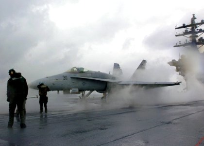 US Navy 051028-N-7359L-001 An F-A-18C Hornet, assigned to the Bulls of Strike Fighter Squadron Three Seven (VFA-37), is directed onto a steam-powered catapult