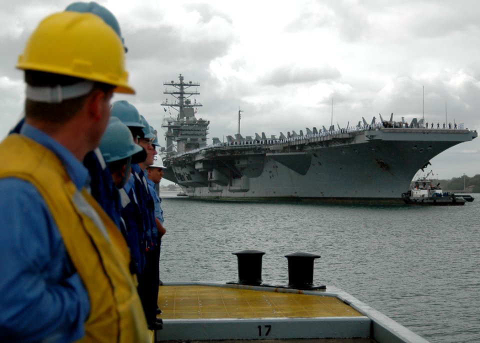 US Navy 051030-N-3019M-004 Line handlers assigned to Naval Station Pearl Harbor watch as the nuclear-powered aircraft carrier USS Nimitz (CVN 68) enters Pearl Harbor, Hawaii for a brief port visit