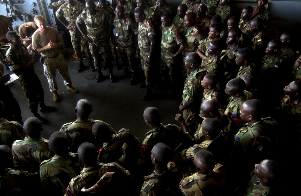 US Navy 051103-F-5789F-147 U.S. Navy Lt. Cmdr. John McLaughlin, left, briefs members of the Senegalese 90th Naval Infantry in ship boarding procedures aboard the dock landing ship USS Gunston Hall (LSD 44) during the West Afric