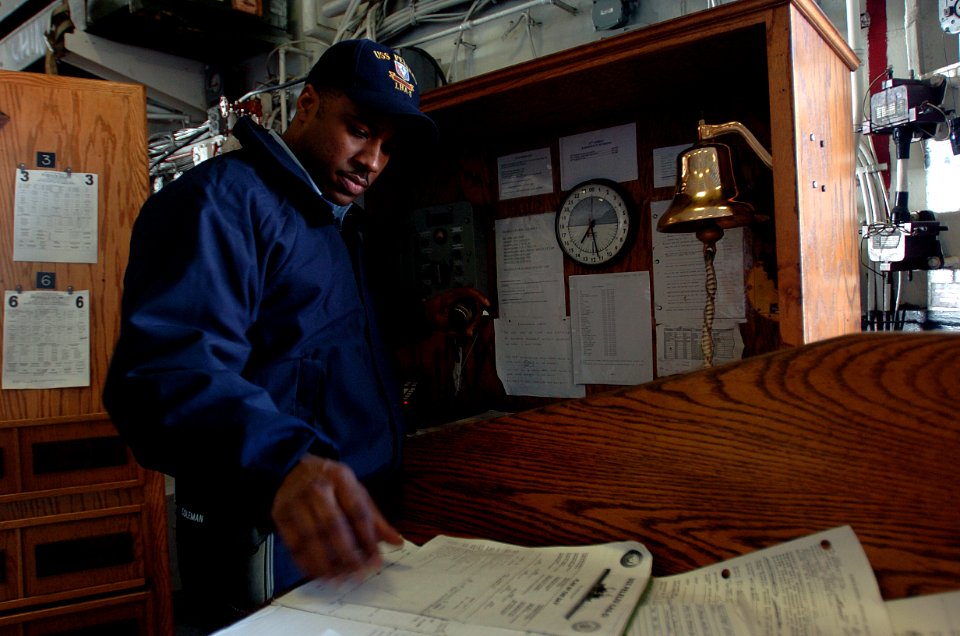 US Navy 051104-N-9866B-001 Store Keeper 2nd Class Eric Coleman prepares to make an announcement over the 1MC intercom while serving as Petty Officer of the Watch aboard the amphibious assault ship USS Peleliu (LHA 5)