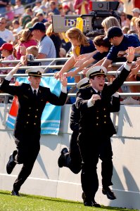 US Navy 051105-N-9693M-006 U.S. Naval Academy Midshipmen race across the end zone fence celebrating one of four first quarter touchdowns against Tulane