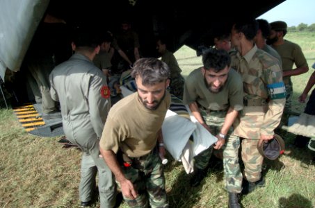 US Navy 051014-N-8796S-189 Pakistani soldiers carry an injured woman off of a U.S. Navy MH-53E Sea Stallion helicopter in Chaklala, Pakistan