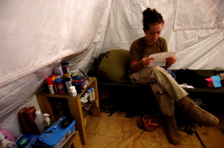 US Navy 051122-F-7234P-005 U.S. Navy Petty Officer 3rd Class Jessica Young reads a letter that was delivered via convoy from Camp Lemonier, Djibouti, to her camp in Harar, Ethiopia