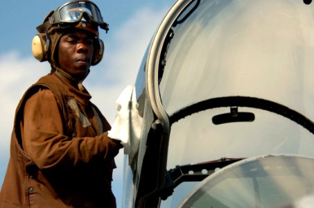 US Navy 051202-N-3488C-083 A plane captain assigned to the Diamondbacks of Strike Fighter Squadron One Zero Two (VFA-102), hand wipes a canopy of one of his squadron's F-A-18F Super Hornets