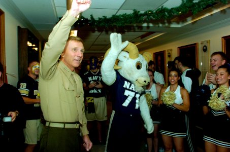 US Navy 051130-N-2568S-002 Commandant of the Marine Corps Gen. Michael Hagee and the U.S. Naval Academy mascot Bill the Goat wave to the crowd during a Pep-Rally