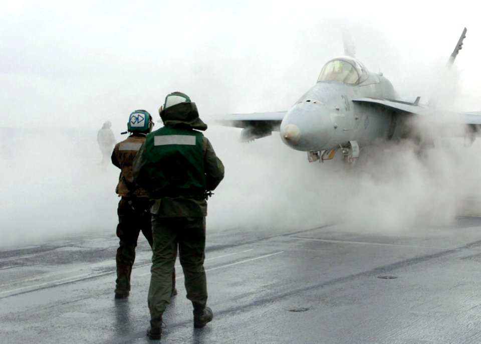 US Navy 051028-N-7359L-002 An F-A-18C Hornet, assigned to the Bulls of Strike Fighter Squadron Three Seven (VFA-37), is directed onto a steam-powered catapult