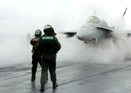US Navy 051028-N-7359L-002 An F-A-18C Hornet, assigned to the Bulls of Strike Fighter Squadron Three Seven (VFA-37), is directed onto a steam-powered catapult