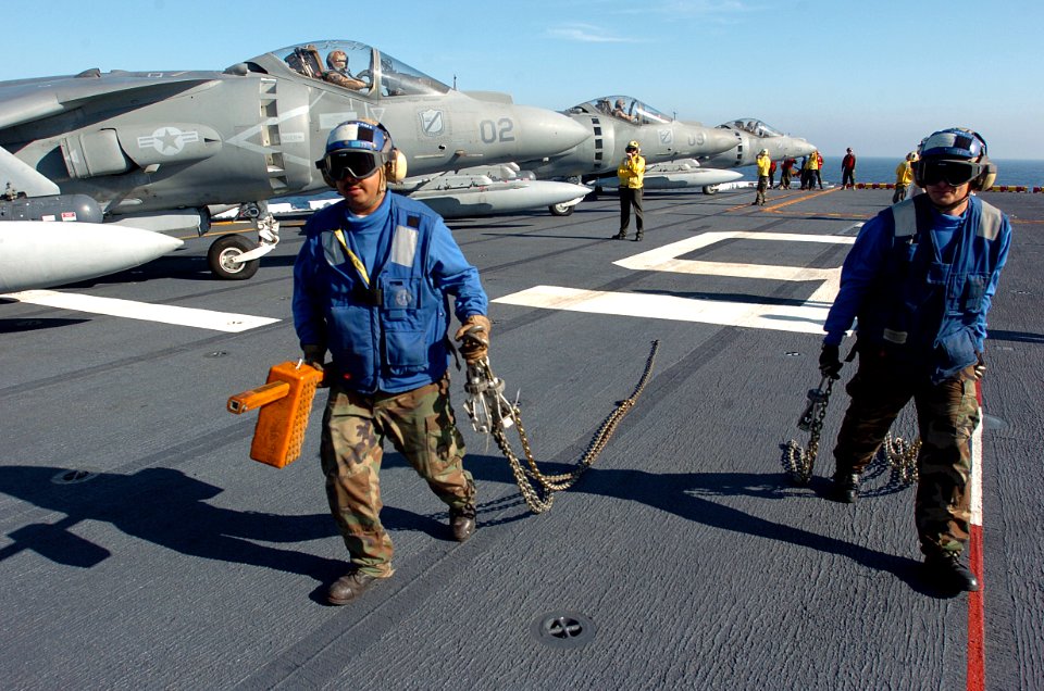US Navy 051114-N-9866B-184 Aviation Boatswain's Mates assigned to Air Department remove the chains from a U.S. Marine Corps AV-8B Harrier