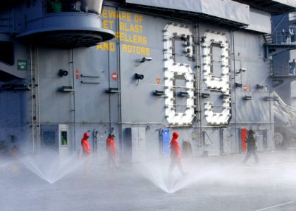 US Navy 051020-N-7359L-001 Air Department personnel check sprinklers on the flight deck while conducting a countermeasure wash down exercise aboard the Nimitz-class aircraft carrier USS Dwight D. Eisenhower (CVN 69)