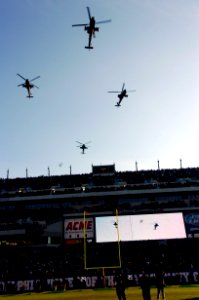 US Navy 051203-N-9693M-001 Army Cobra attack helicopters conduct a fly-over during opening ceremonies at the 106th playing of Army vs. Navy Football game