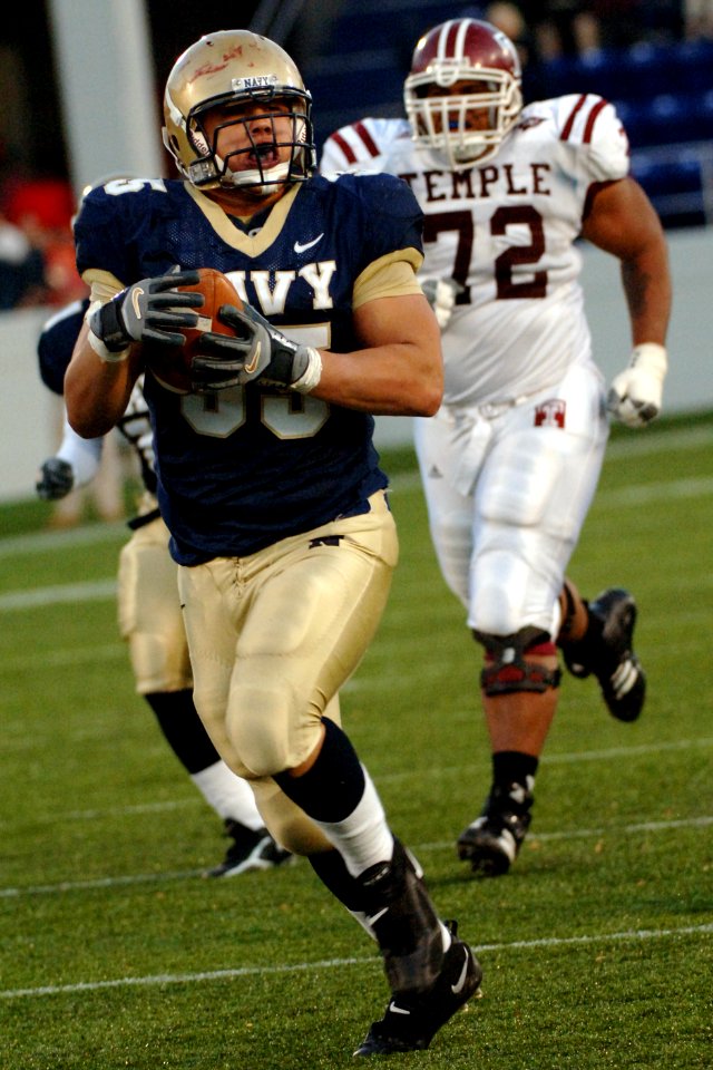 US Navy 051119-N-9693M-024 U.S. Naval Academy Midshipman defensive end John Chan (95) runs in a 41 yard touchdown while being chased by Temple's Stan Primus following an Owls fumble during the 4th quarter of play at Navy-Marine