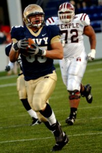 US Navy 051119-N-9693M-024 U.S. Naval Academy Midshipman defensive end John Chan (95) runs in a 41 yard touchdown while being chased by Temple's Stan Primus following an Owls fumble during the 4th quarter of play at Navy-Marine