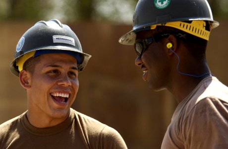 US Navy 051108-F-7234P-002 U.S. Navy Constructionman Jaime Hernandez, assigned to Naval Mobile Construction Battalion Three (NMCB-3), speaks with his co-worker, Petty Officer 3rd Class Terence Ruben