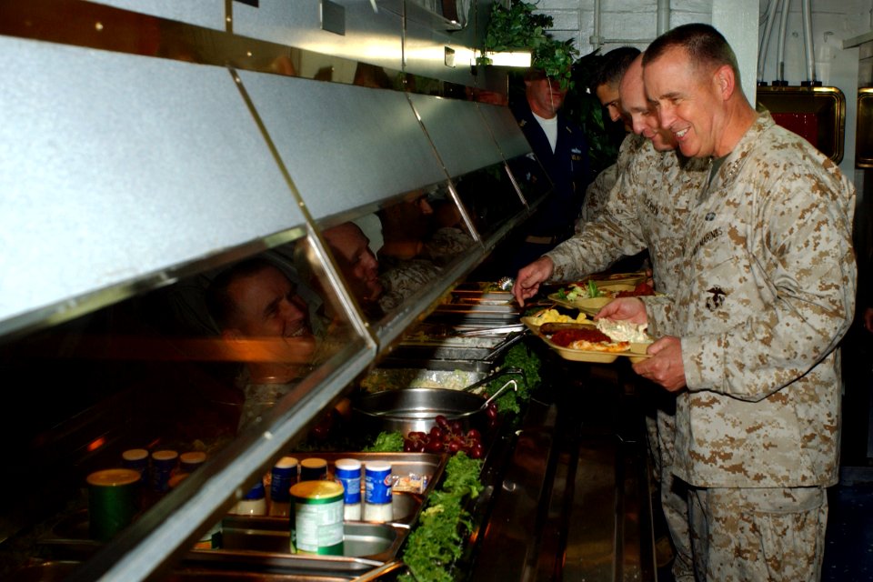 US Navy 051115-N-9866B-403 Commanding General, 1st Marine Expeditionary Force, Lt. Gen. John F. Sattler and Commanding General, Expeditionary Strike Group Three (ESG-3), Brig. Gen. Carl Jensen, prepare to eat with Marines