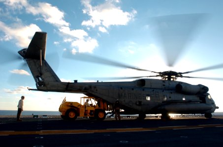 US Navy 051203-N-9866B-057 Combat Cargo Marines assigned to the 11th Marine Expeditionary Unit load equipment on a CH-53 Super Stallion helicopter on the flight deck of the amphibious assault ship USS Peleliu (LHA 5)