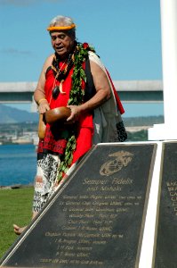 US Navy 051114-N-3019M-006 A native Hawaiian performs a blessing during a ceremony dedicating a new flagstaff and display of bronze plaques commemorating 73 Marines who gave their lives and 15 survivors of the attack on the bat