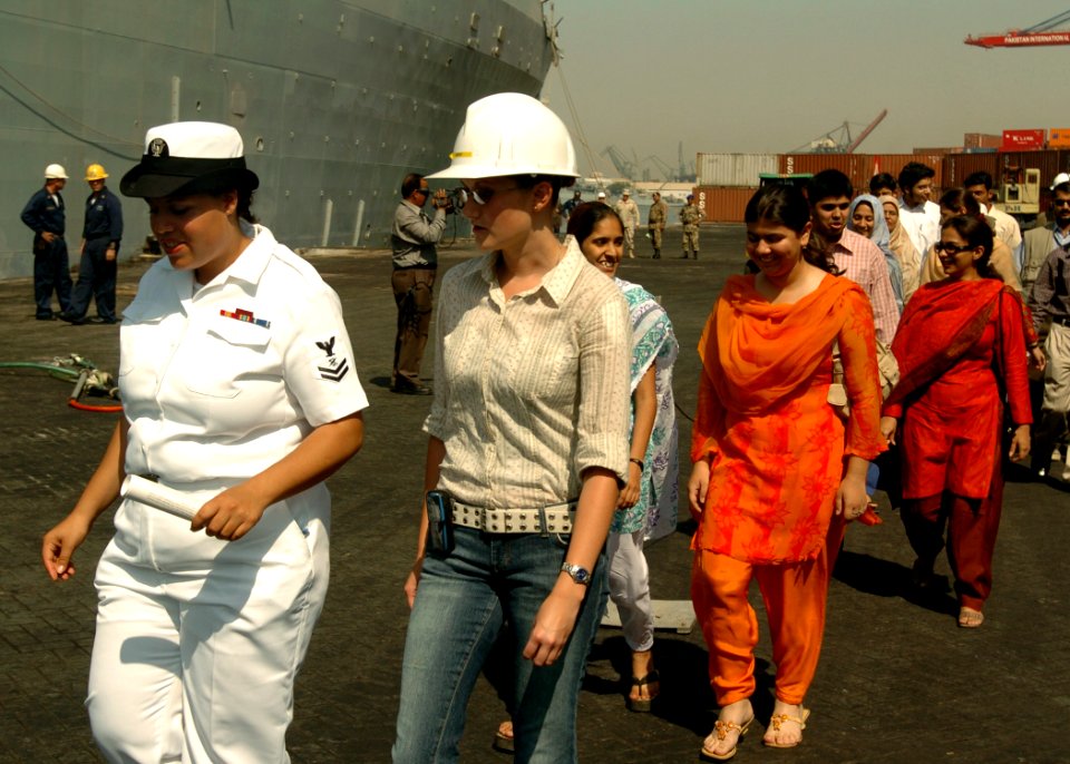 US Navy 051024-N-0716S-009 U.S. Navy Journalist 2nd Class Rebekah Adler leads a group of young Pakistanis for a tour of the dock landing ship USS Pearl Harbor (LSD 52) in Karachi, Pakistan