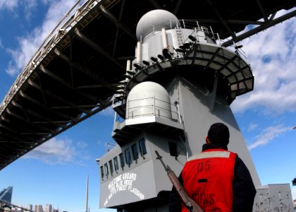 US Navy 051119-N-7526R-111 Gunner's Mate Seaman Donald Snyder, watches as amphibious command ship USS Blue Ridge (LCC 19) narrowly passes under Tokyo's Rainbow Bridge